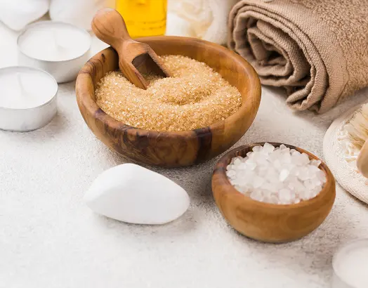 Spa scrub with bath salts, towels, and candles